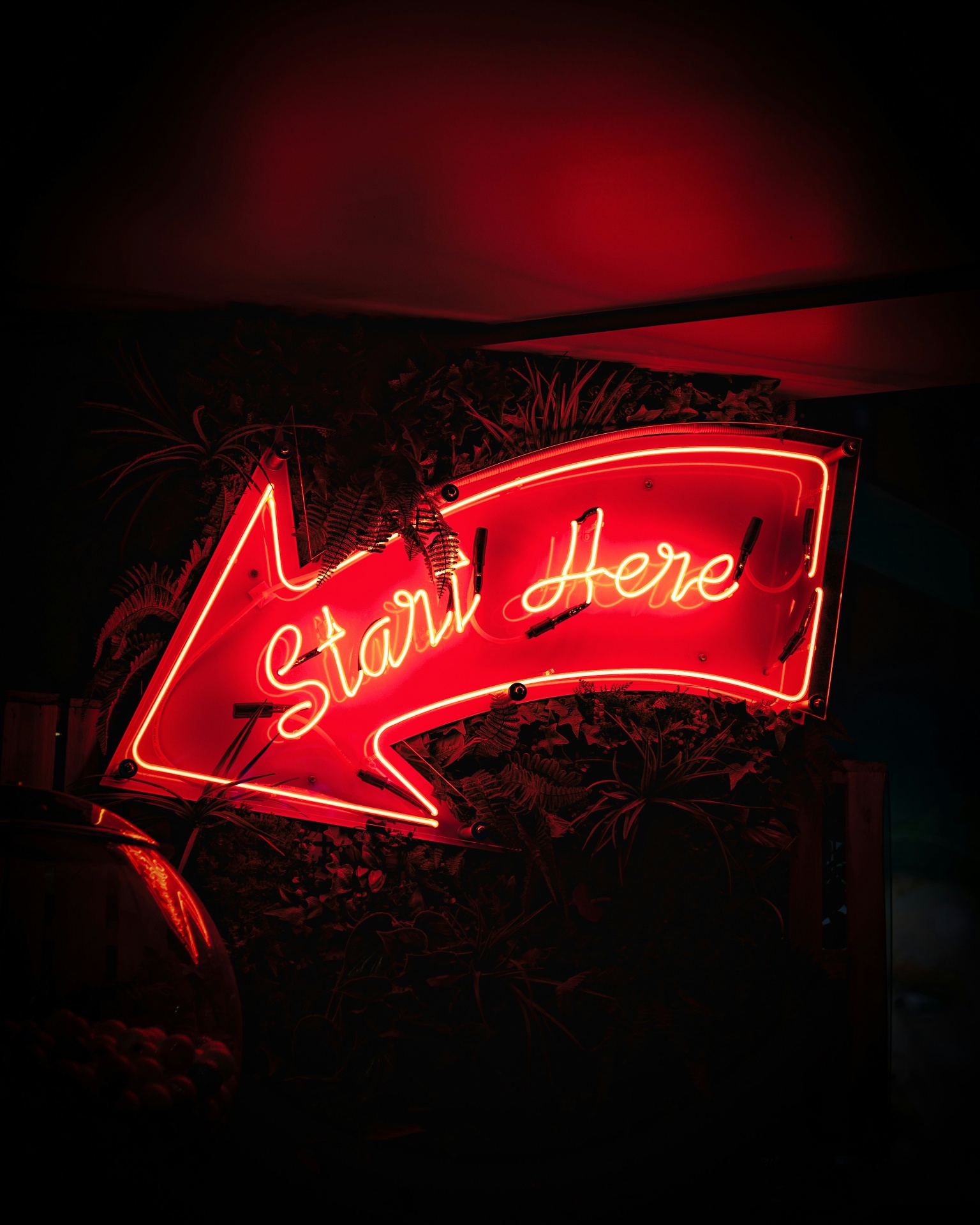 Neon sign reading Start Here